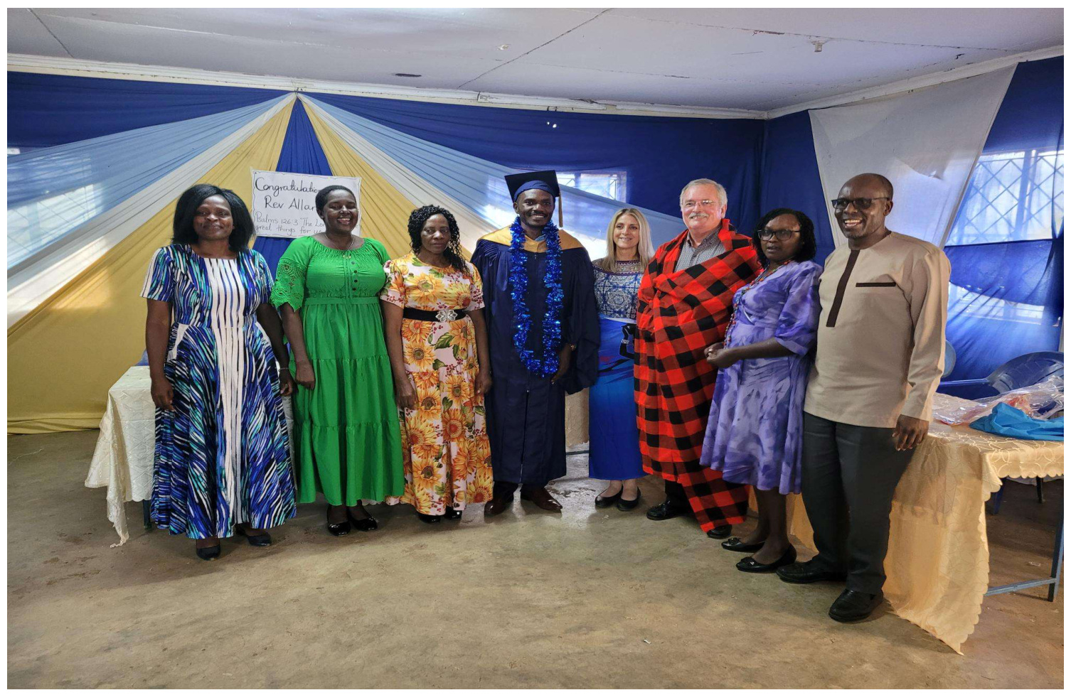 Pastor Allan Kiptangus, wife Josephine, and church members