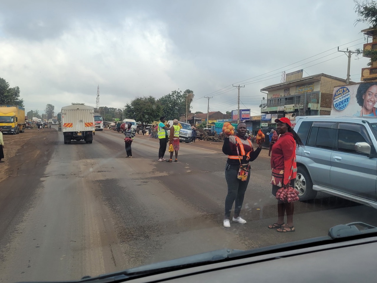 Women selling fruit to passing traffic on a Kenyan roadside