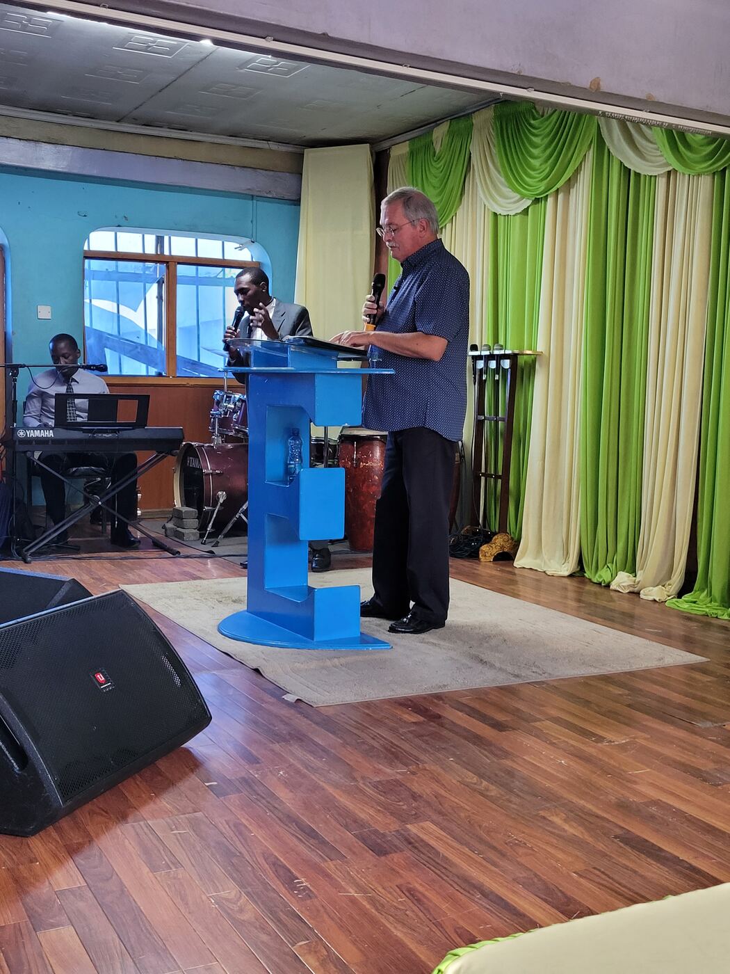 Mike Bourassa preaching at a church podium in Nairobi