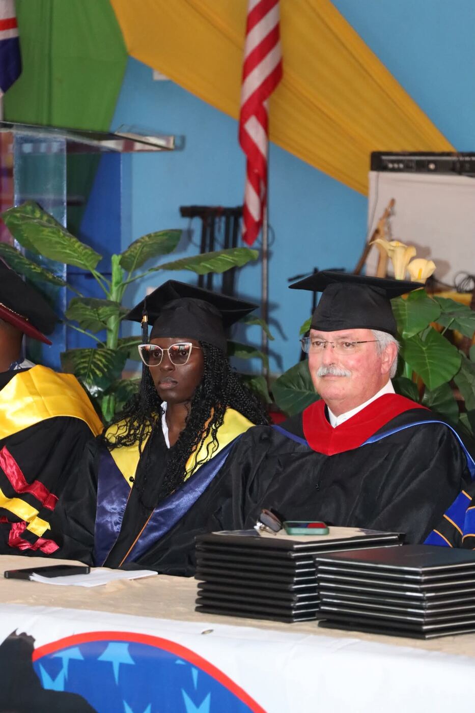 A graduate with Professor Mike at the diploma table