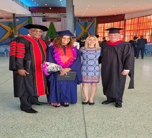 A graduate with Professor Mike and Tonya Bourassa