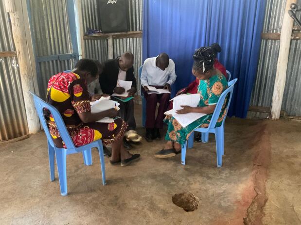 Church leaders in Bomet, Kenya reviewing their leadership training homework in small groups