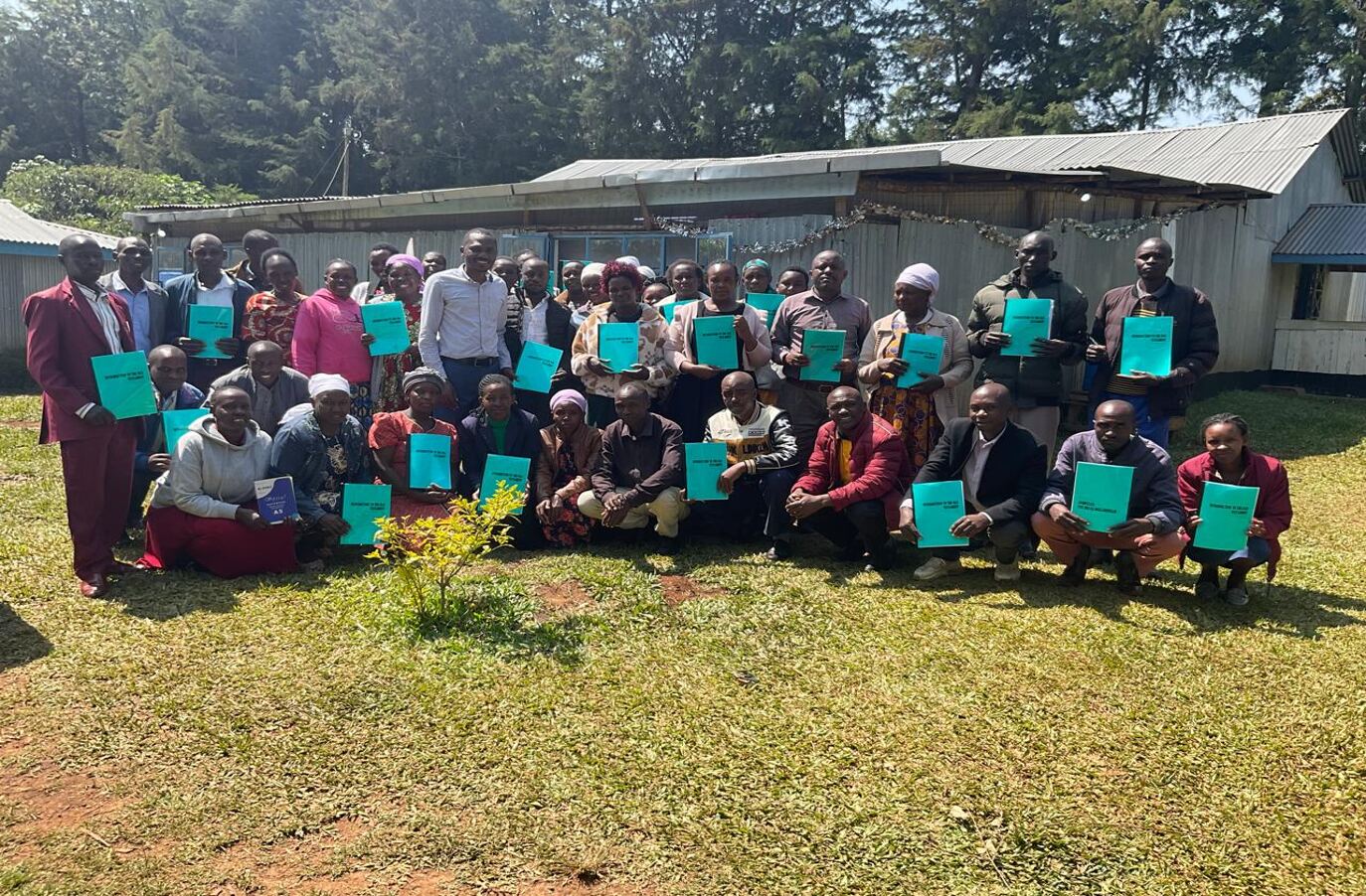 Pastor Allan with most of the church leaders in Bomet, Kenya, showing their first booklet of leadership training material